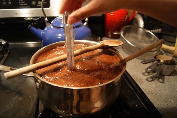 Good trick courtesy of the internets: Lay a wooden spoon over a pot of boiling stuff to keep it from spilling over.