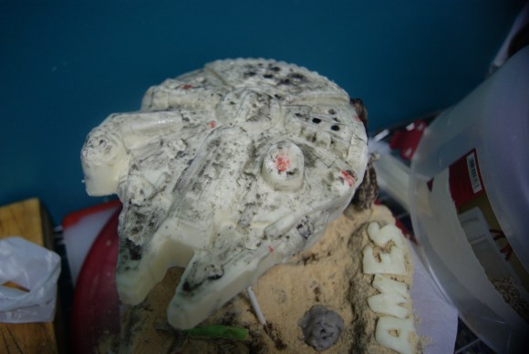 This is a Star Wars- themed cake I made for my boyfriend. The Millenium Falcon piece, also the best piece on this cake, is from an excellent mold. I painted the ship to look super beat-up, as I am very good at making things look super beat-up. :(